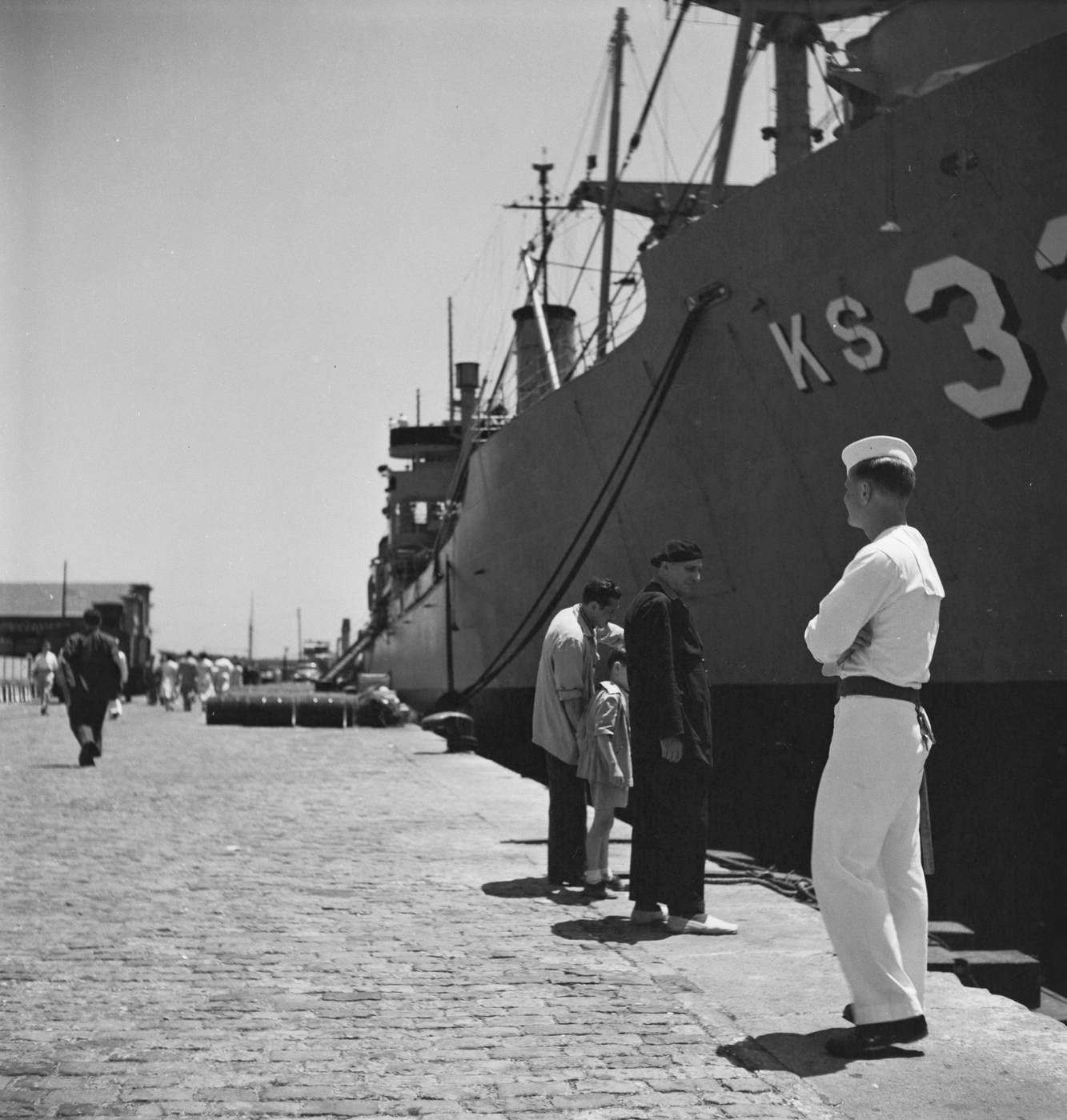 A sailor in front of a ship at the Port of Barcelona.